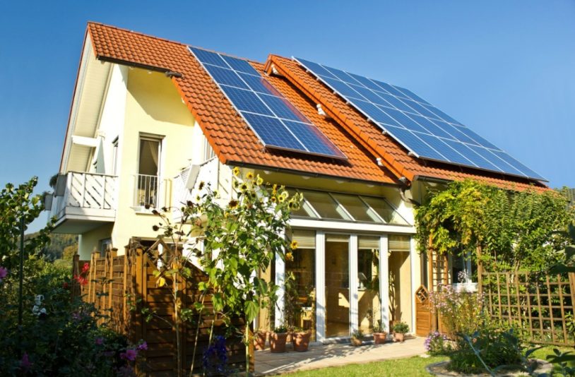house with solar panel and plants