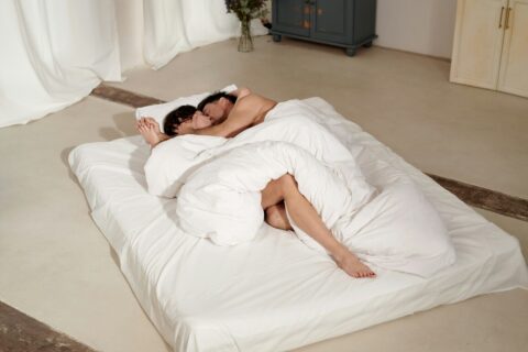 woman and man lying in bed