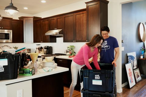 woman-and-man-organizing-items-in-the-box