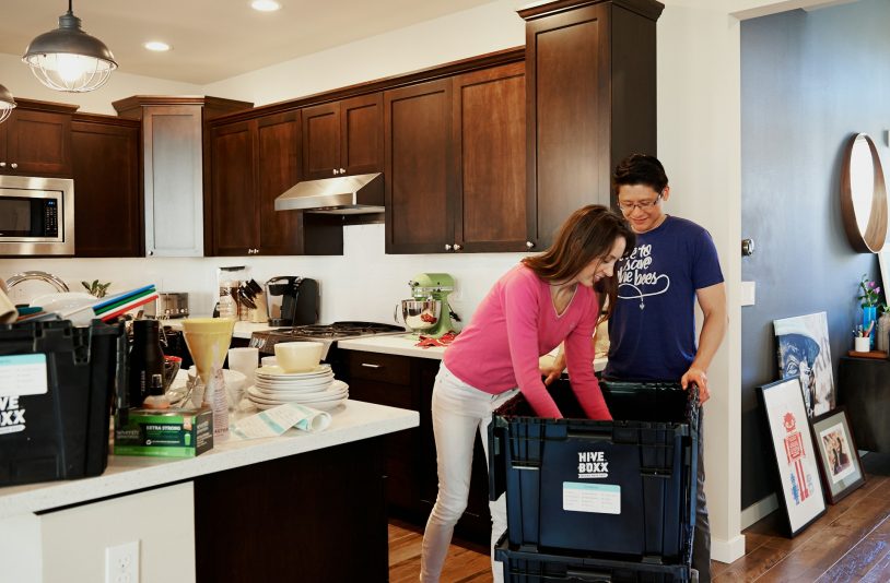 woman-and-man-organizing-items-in-the-box