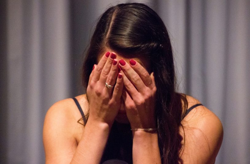 woman covering her face