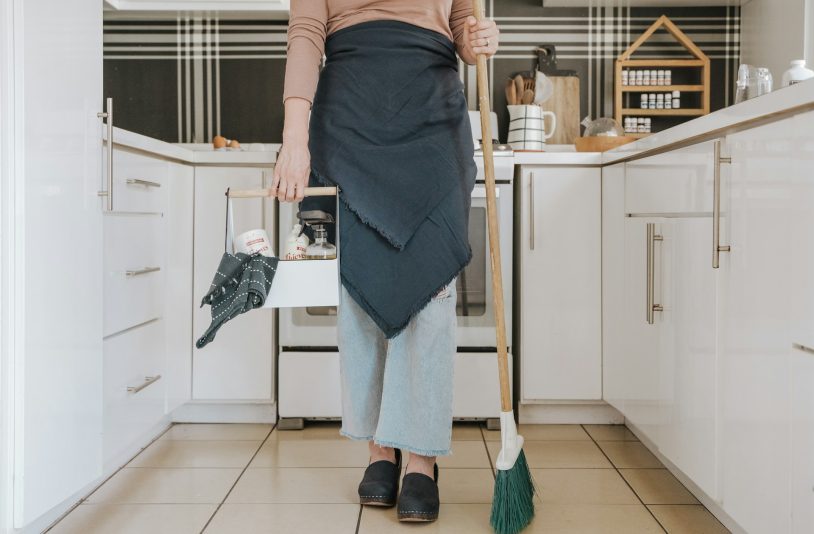 woman holding a broom