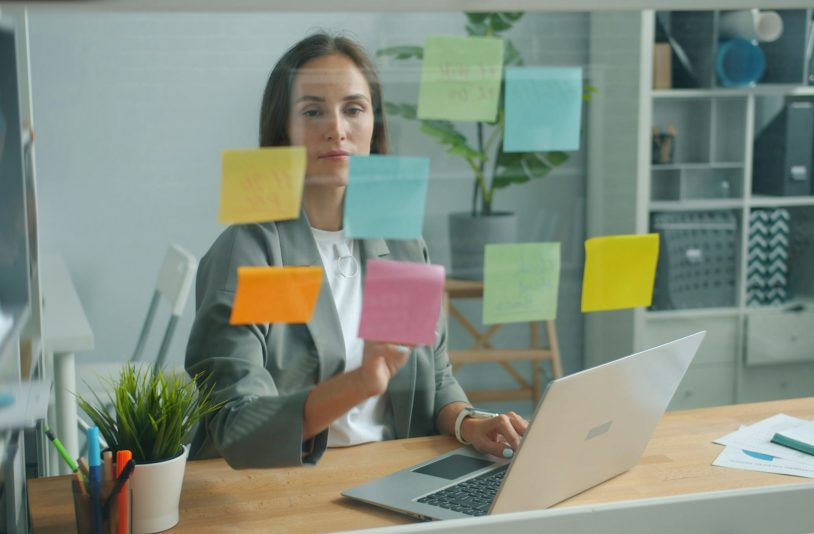 woman placing sticky notes
