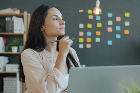 woman thinking at her desk