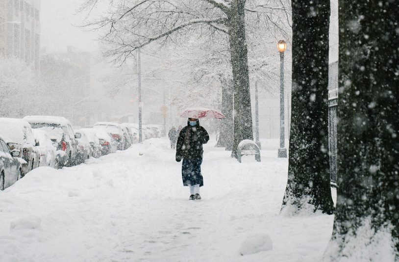 woman walking on snow covered road